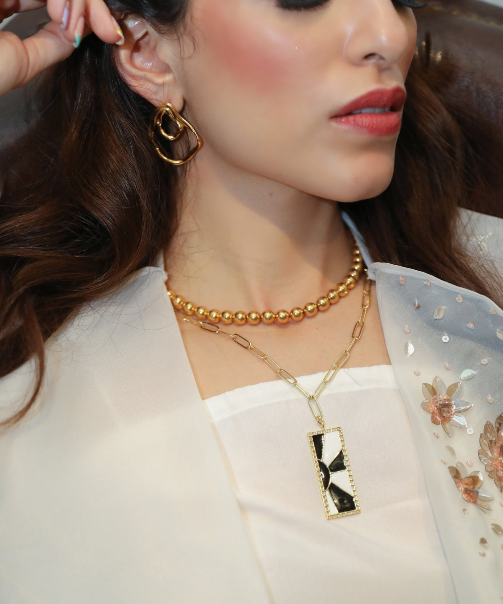 Maia Sethna wearing MNSH Fluid Double Wave Earring